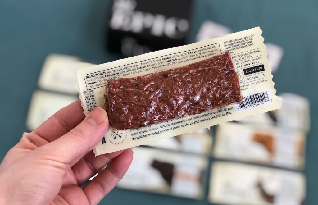 hand holding a protein bar in packaging