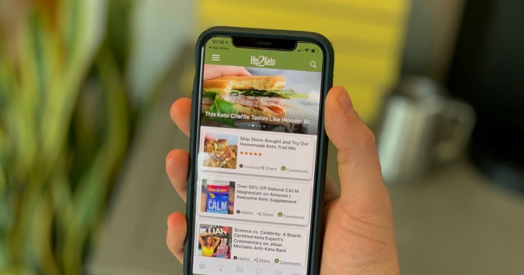 holding iPhone with Hip2Keto app on the screen