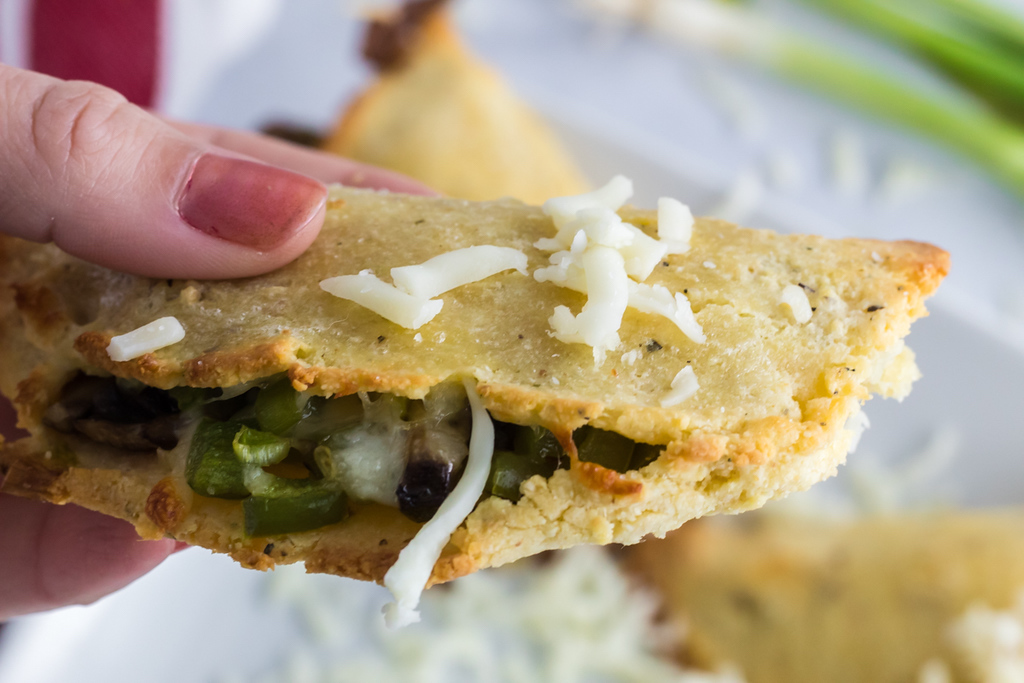 holding keto vegetarian empanada