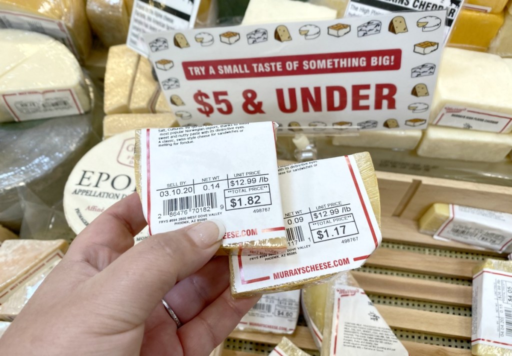 holding small specialty cheeses at the store