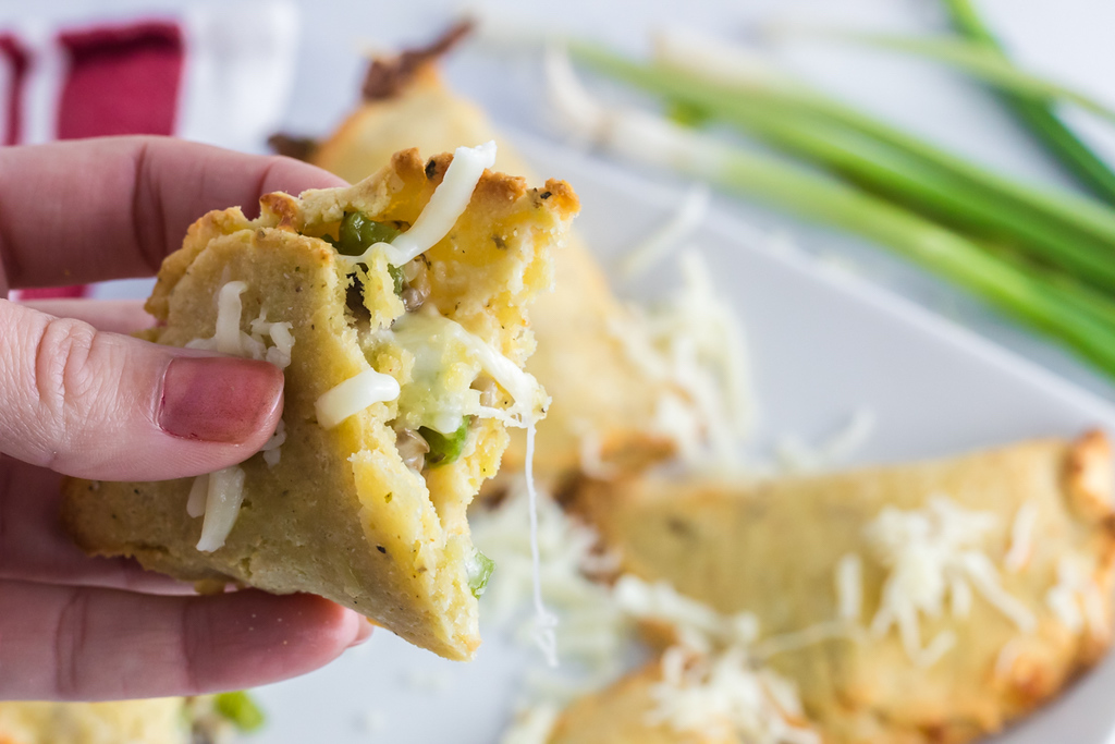 holding keto vegetarian empanada