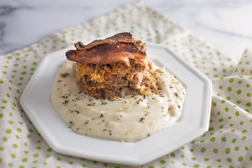 plate of cauliflower mash with piece on top