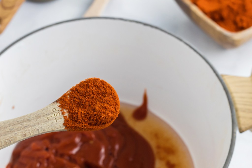 pouring paprika into pan