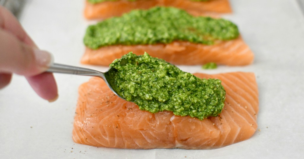 placing pesto on the keto salmon