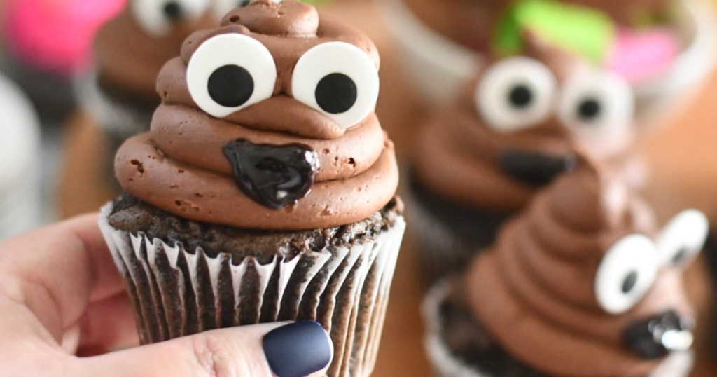 holding poop emoji cupcake 