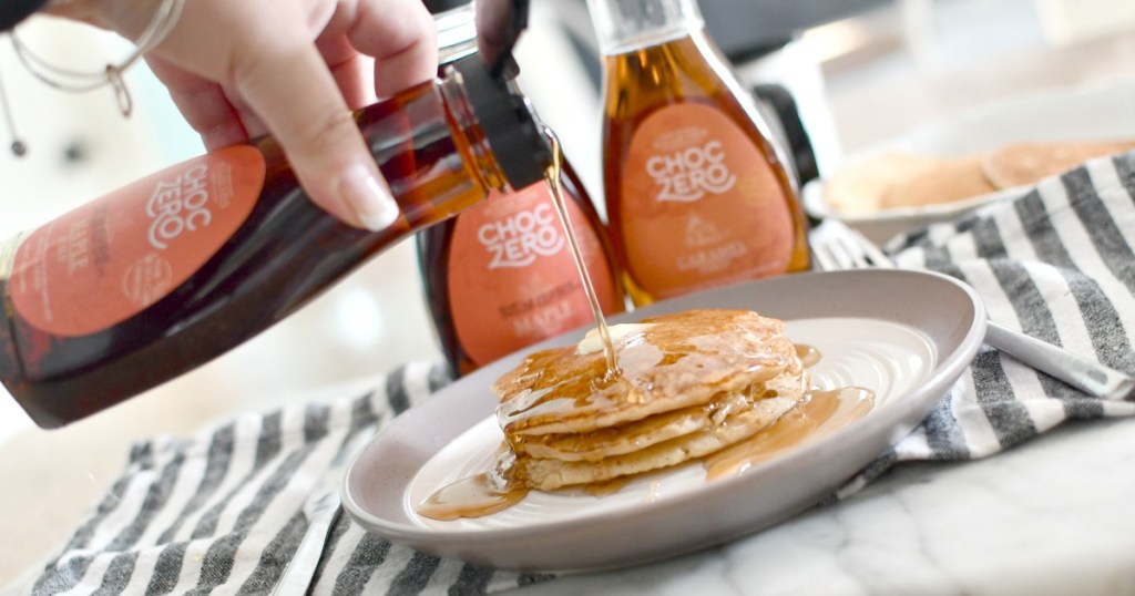 pouring maple keto syrup over pancakes