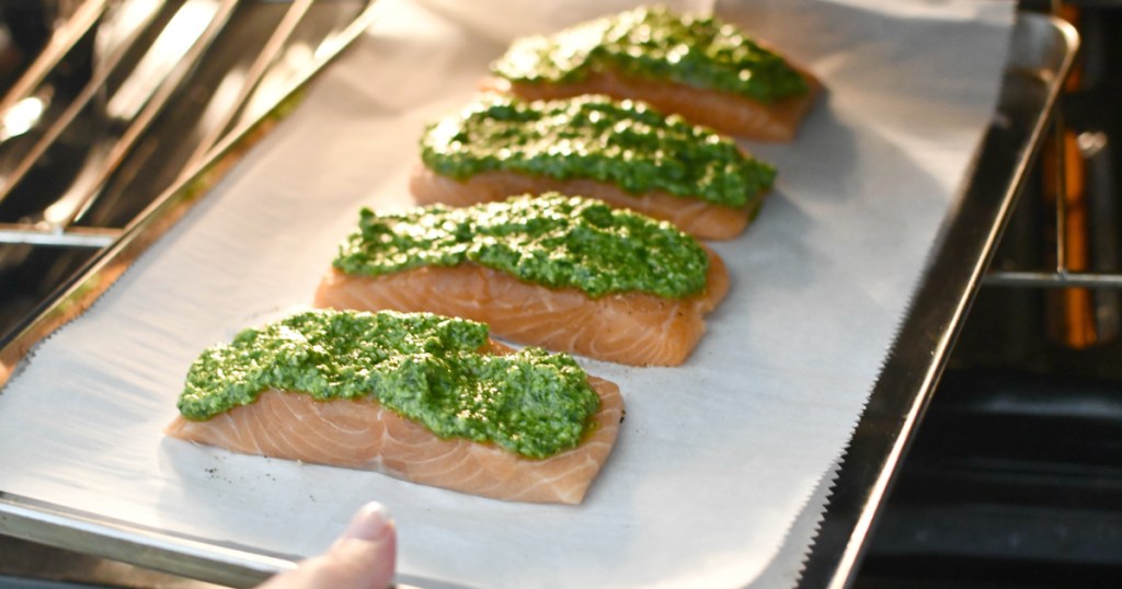 putting cilantro pesto salmon in the oven