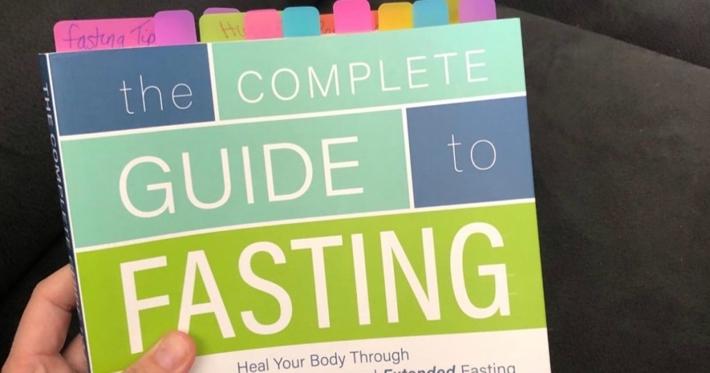 holding The Complete Guide to Fasting book 