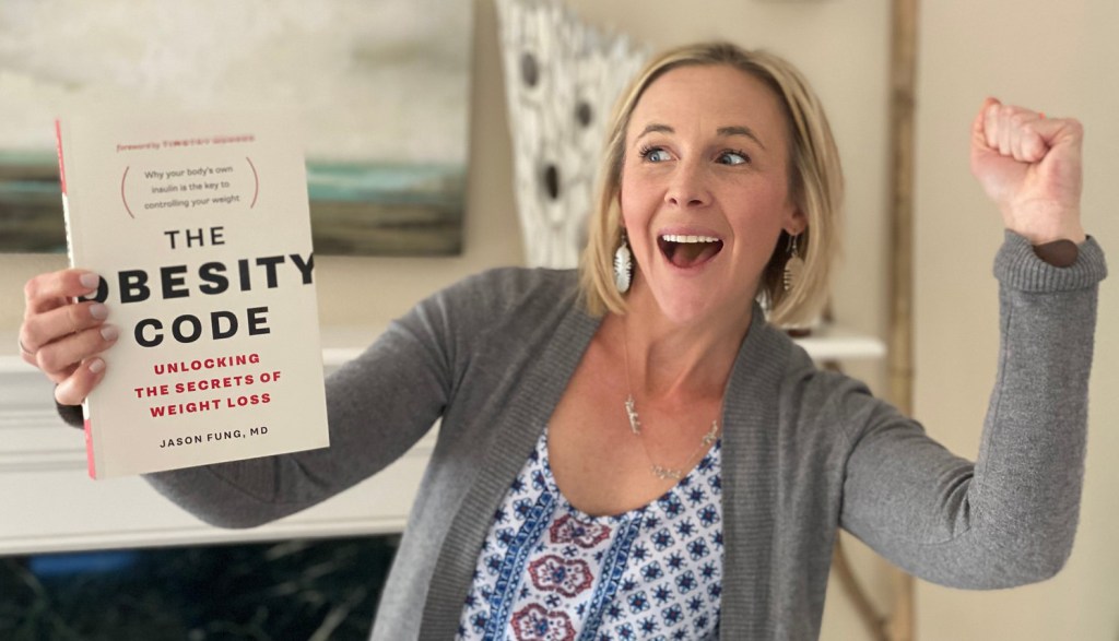 woman holding obesity code book