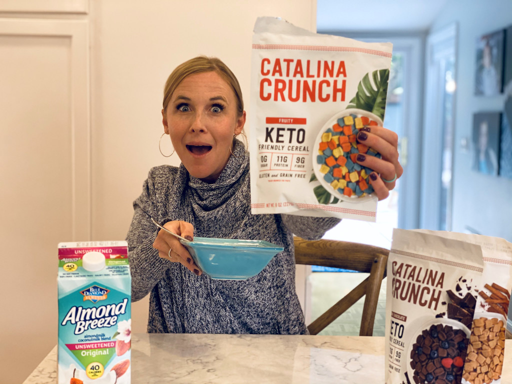 woman holding out Catalina Crunch Keto cereal 