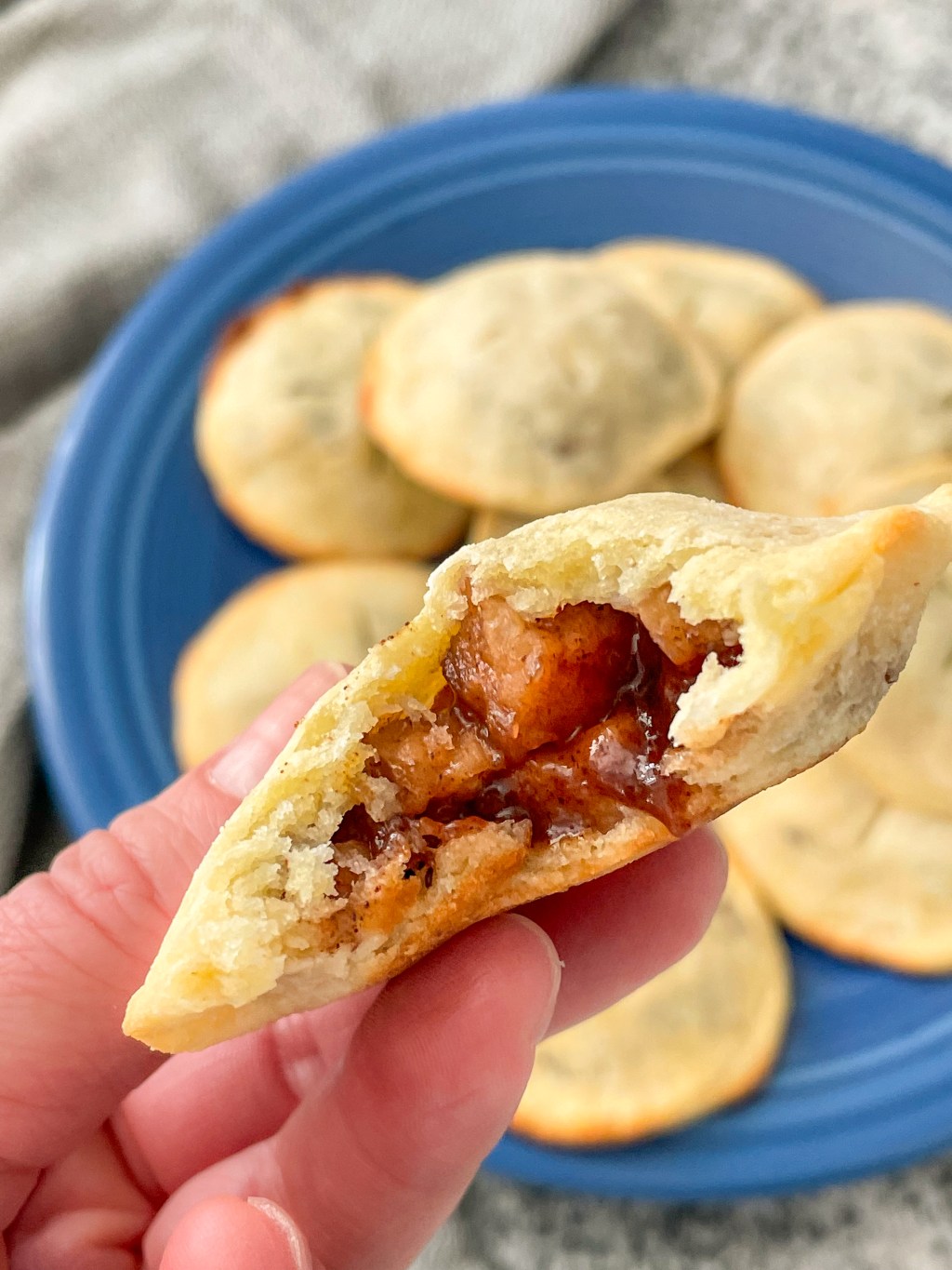 holding keto pie recipe apple hand pie with a bite out of it