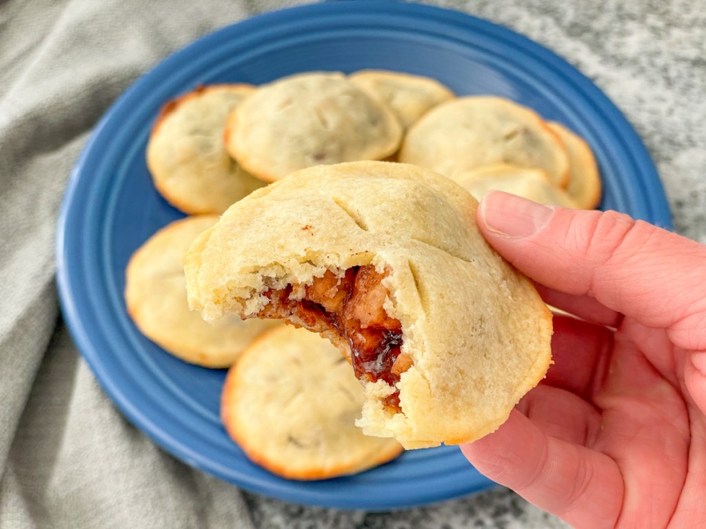 holding keto pie recipe apple hand pie with a bite out of it