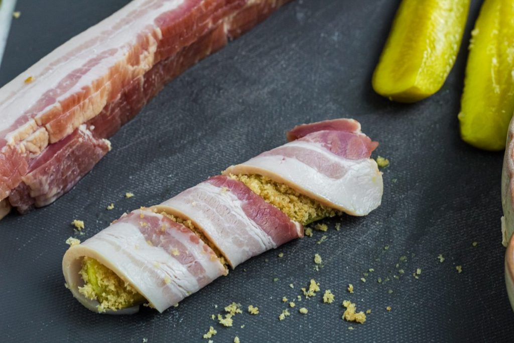 uncooked pickle wrapped in bacon