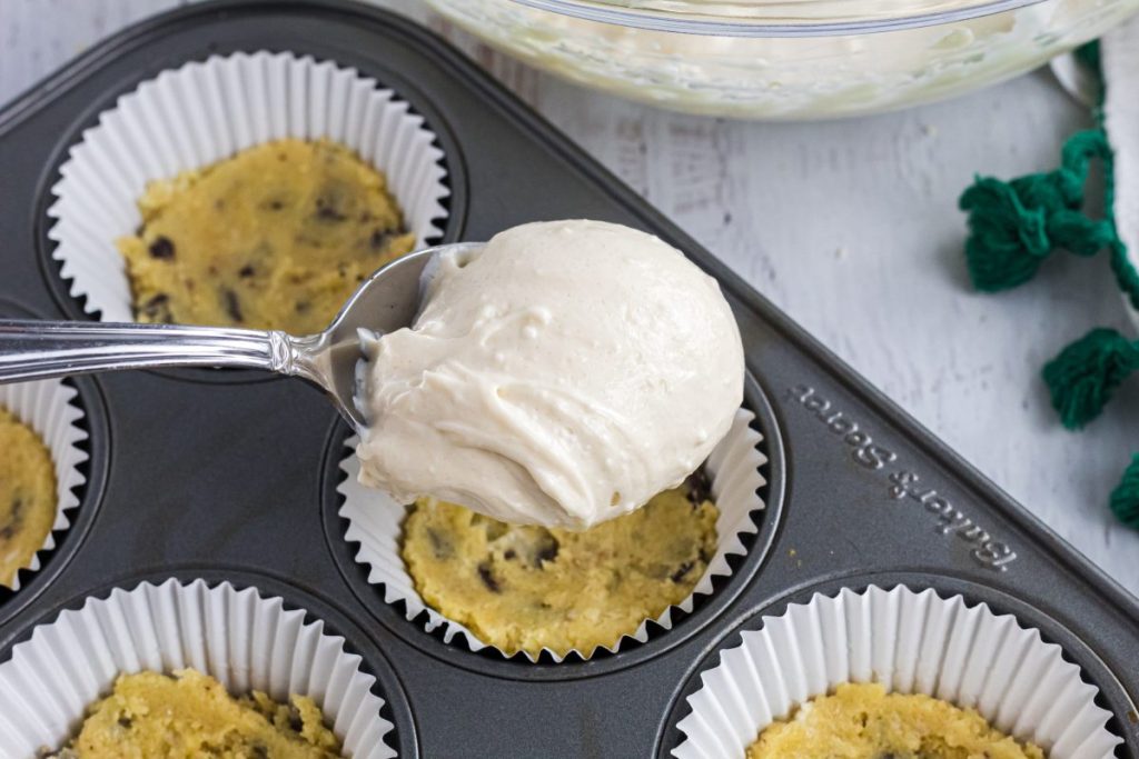 adding cream cheese filling to muffin tin