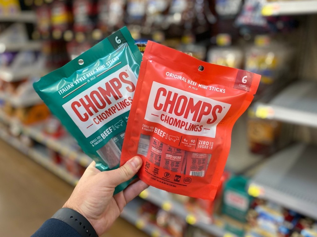 holding 2 bags of Chomplings at Walmart