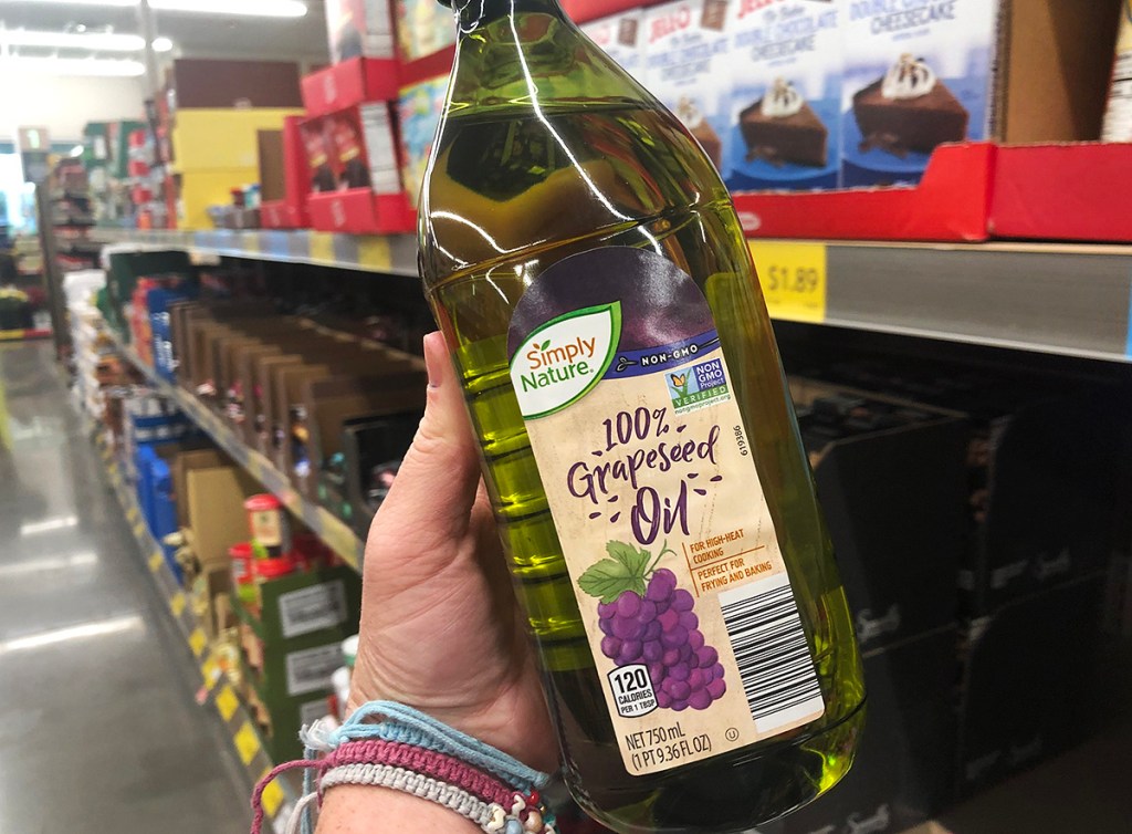 hand holding bottle of grapeseed oil