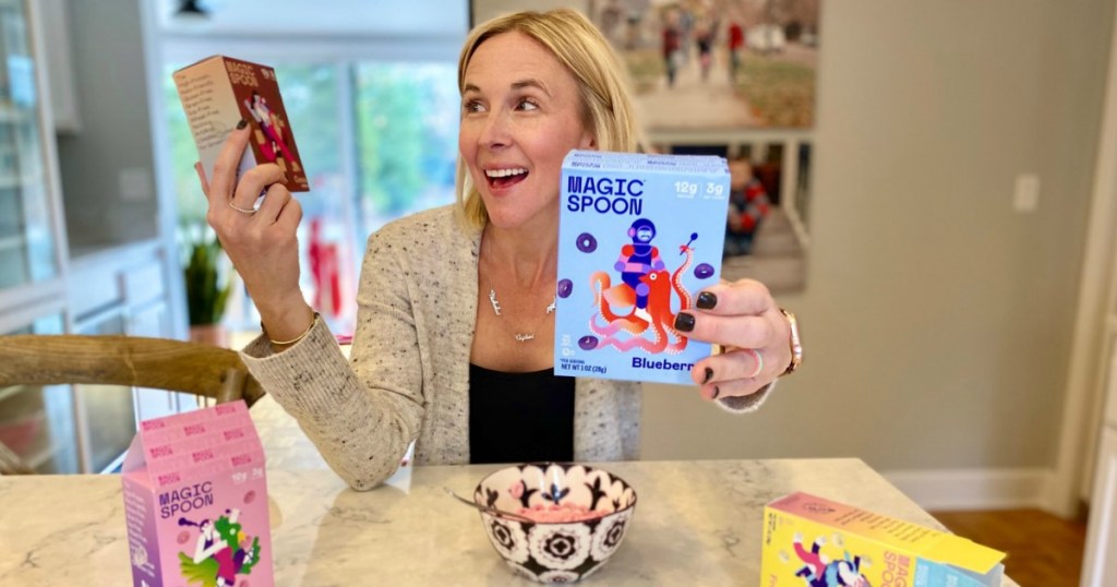 woman holding mini Magic Spoon cereal boxes