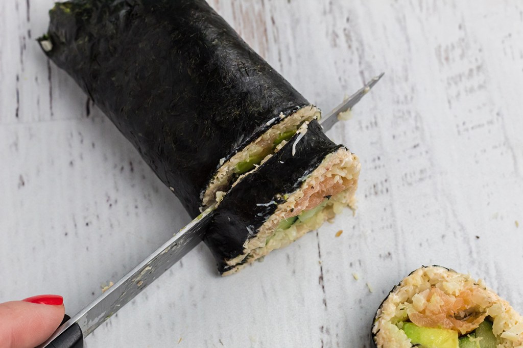 cutting roll of keto sushi