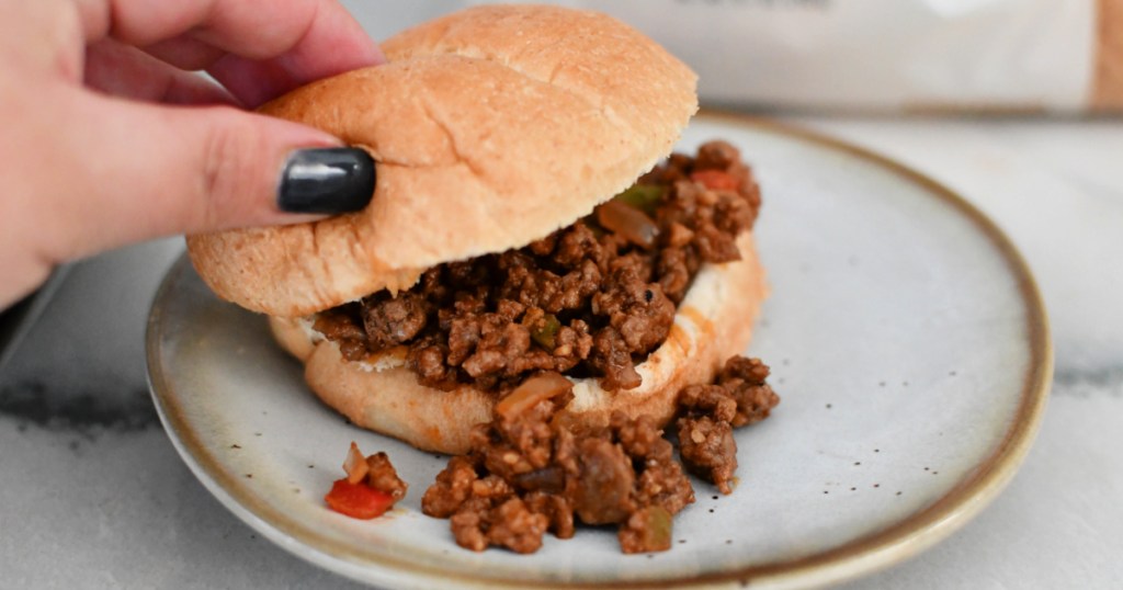 Making a keto sloppy joe with keto bun on a plate. 