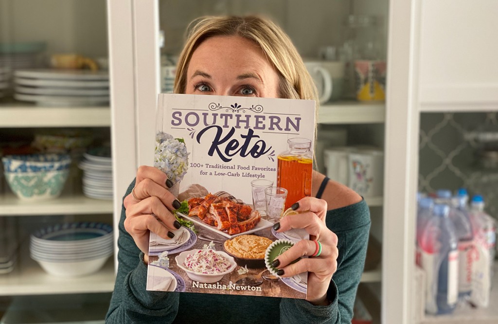 woman holding up southern keto cookbook