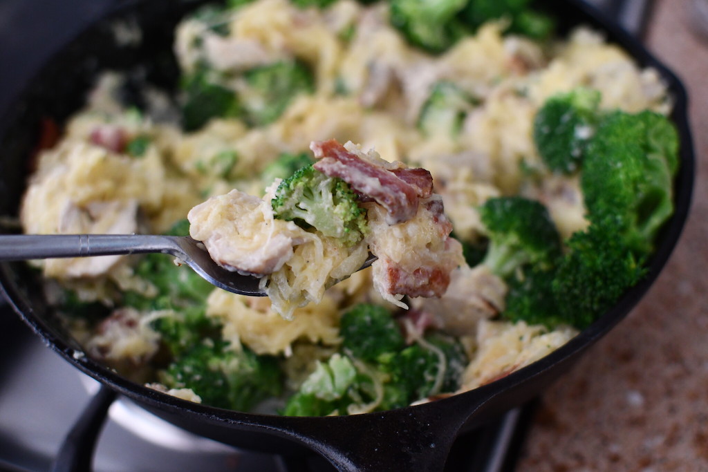 Spaghetti squash with bacon and broccoli in cast iron pan 
