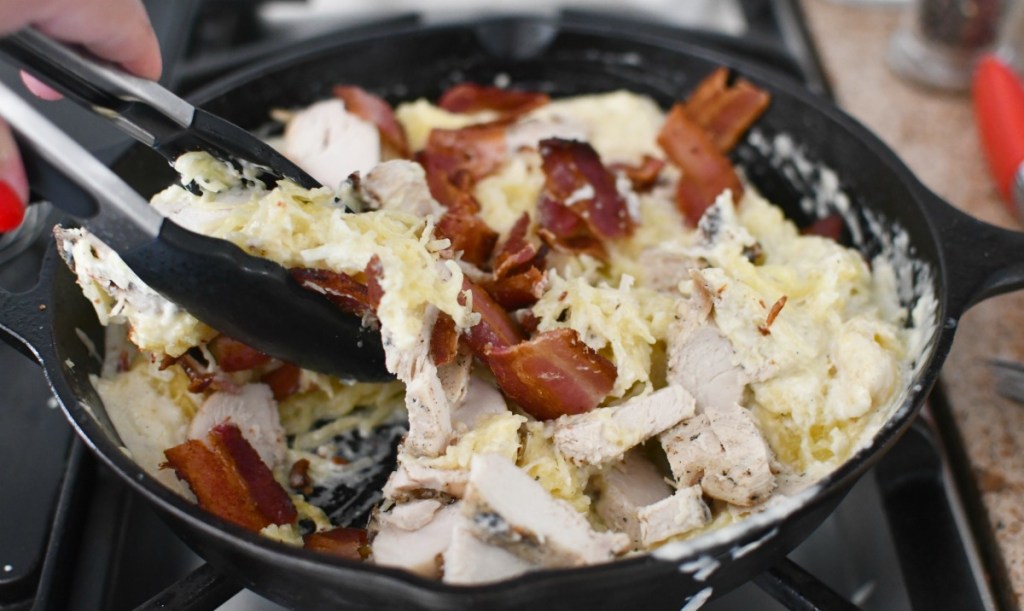 stirring spaghetti squash and chicken skillet