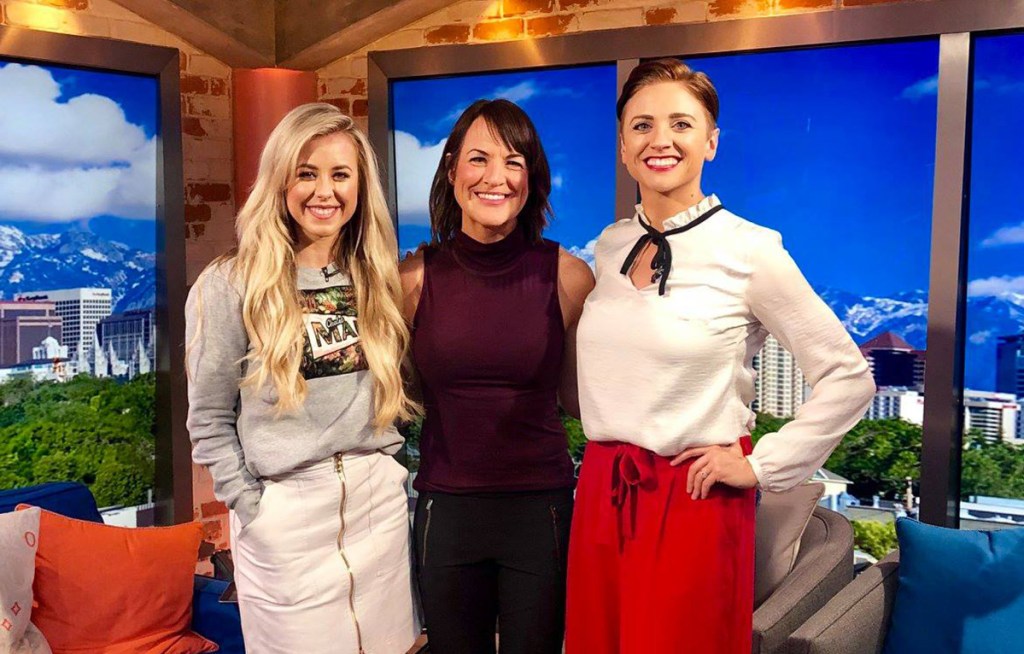 three women standing in television studio