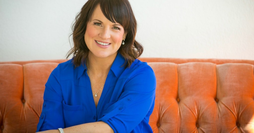 woman in blue blouse sitting on couch