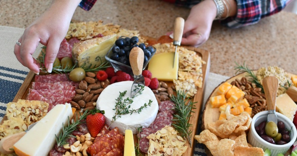 woman dressing up two meat and chees trays 