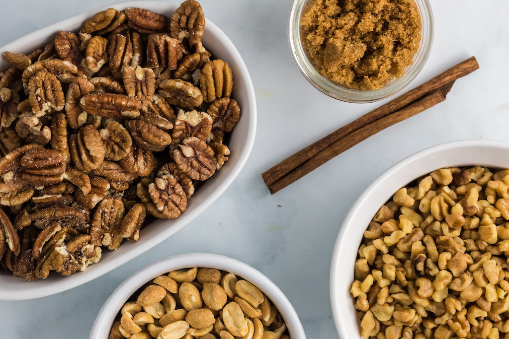 pecans, peanuts, and brown sugar in bowls 