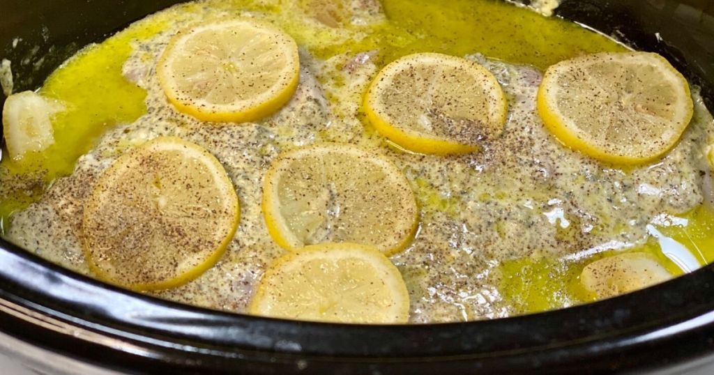 Keto lemon pesto chicken simmering in the slow cooker