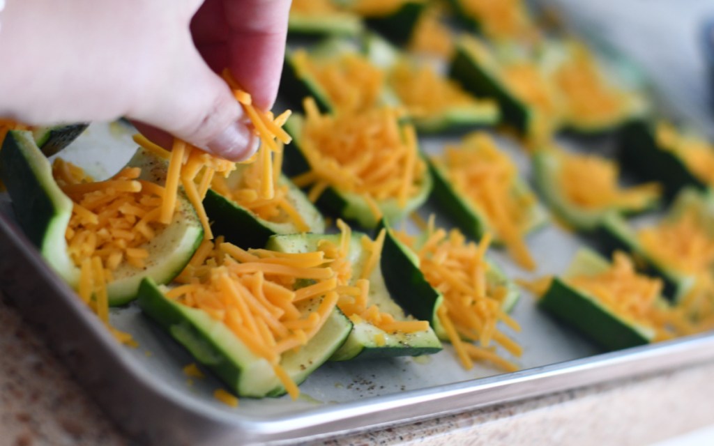 adding cheese to loaded zucchini skins