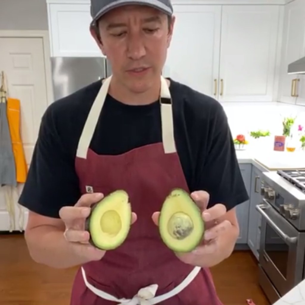Chipotle chef holding 2 avocados