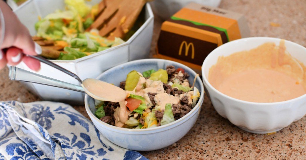 drizzling big mac sauce on salad