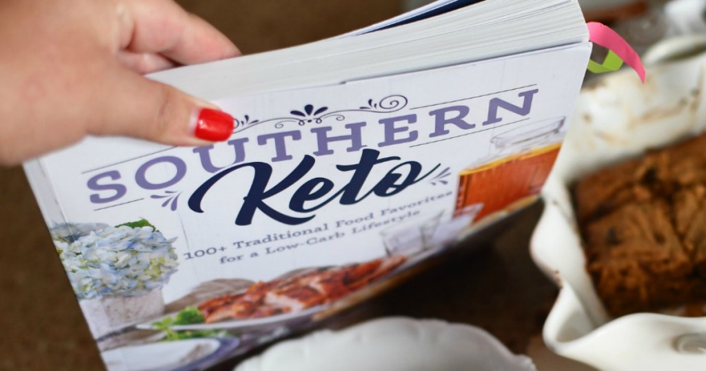 holding Southern Keto Cookbook with keto bars in the background