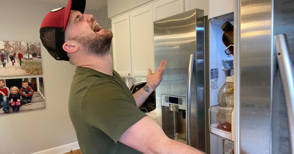 man in front of fridge