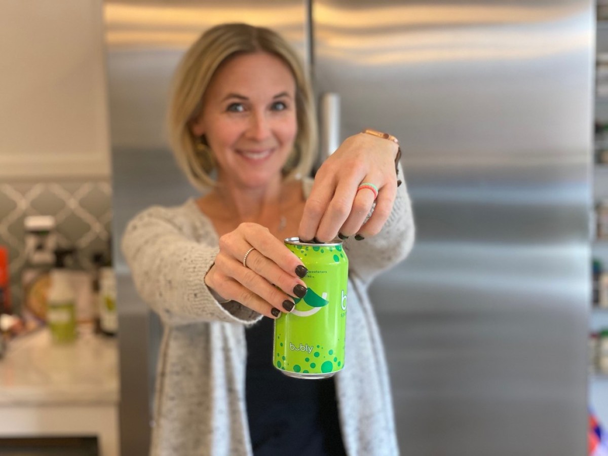 woman opening can of sparkling water