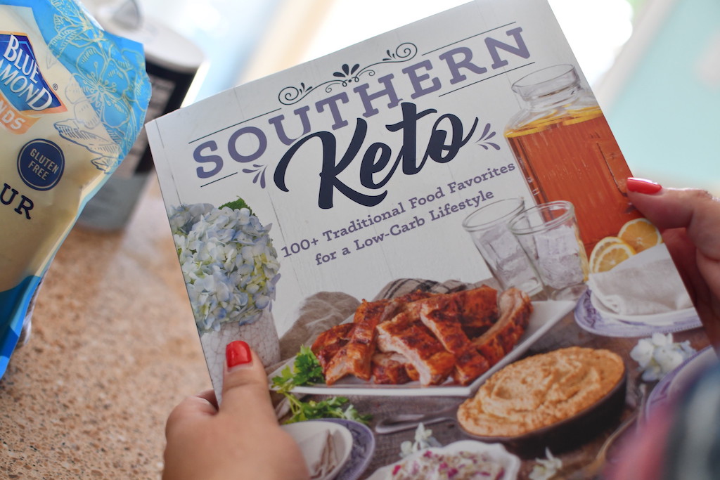 woman holding Southern Keto cookbook