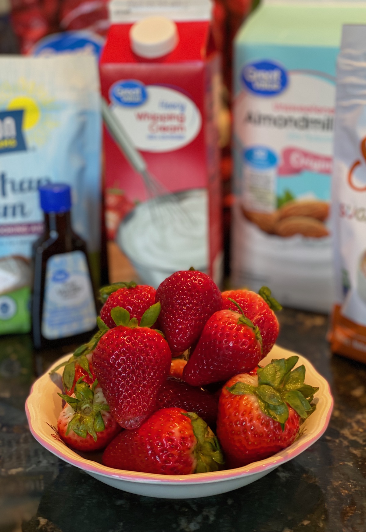 ingredients for keto strawberry milkshake on counter
