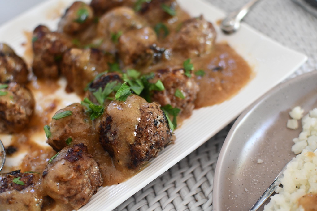 Swedish meatballs with sauce on serving tray 
