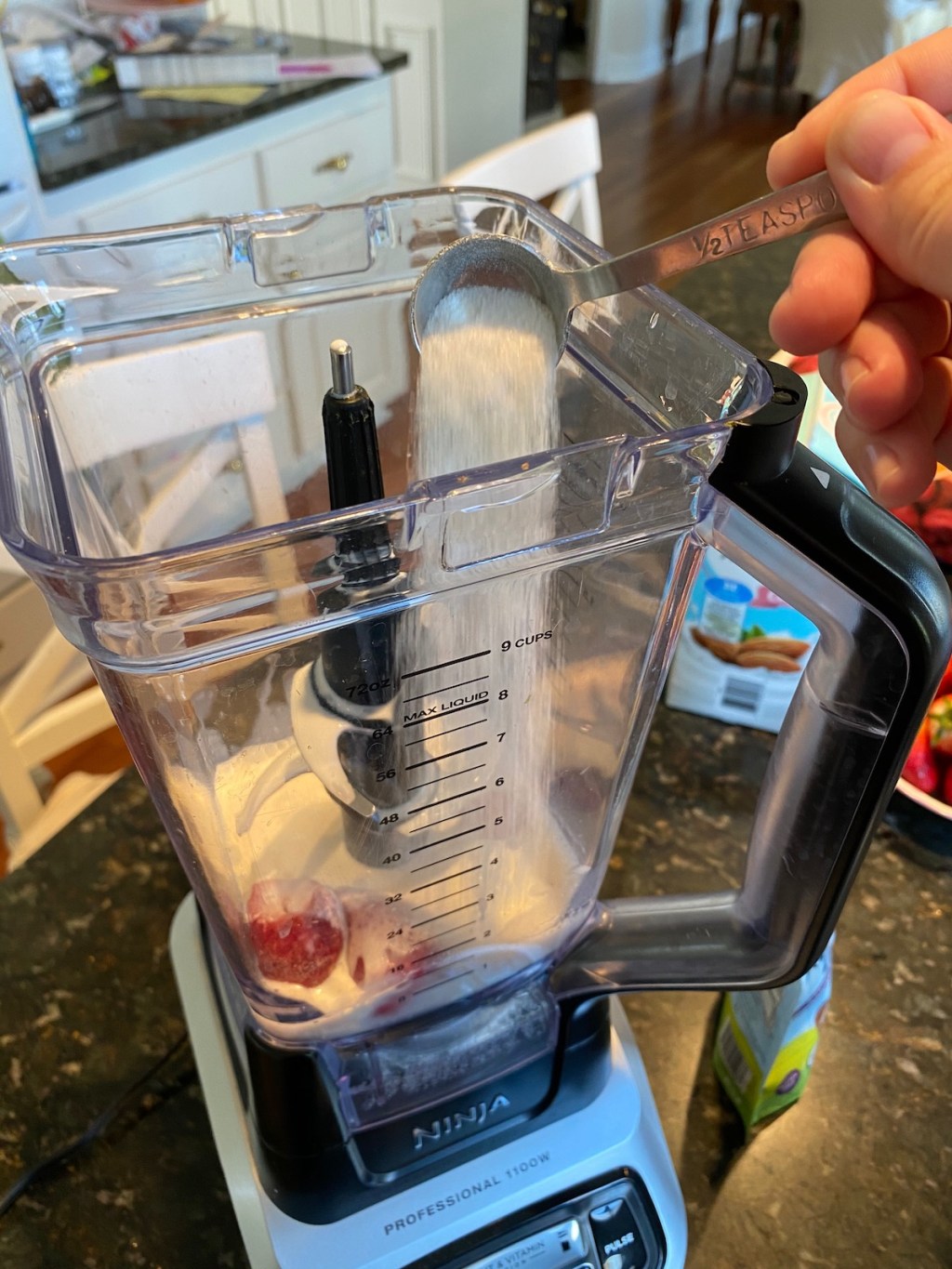 blender with milkshake ingredients mixing inside