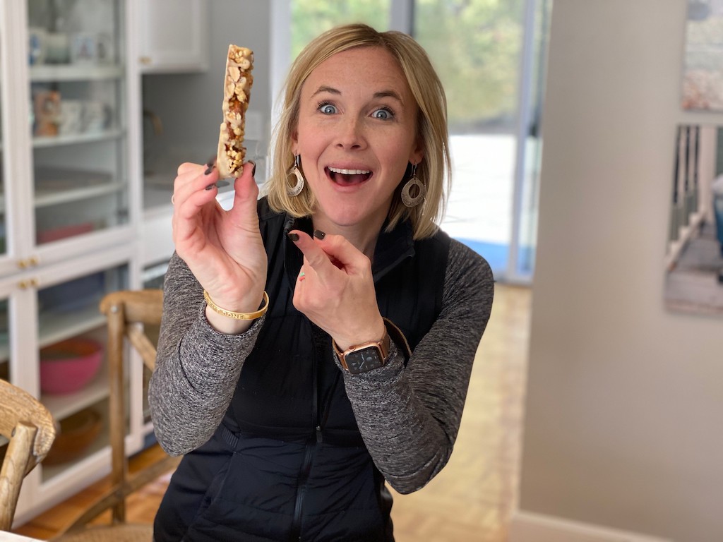 woman holding and pointing at Quest snack bar