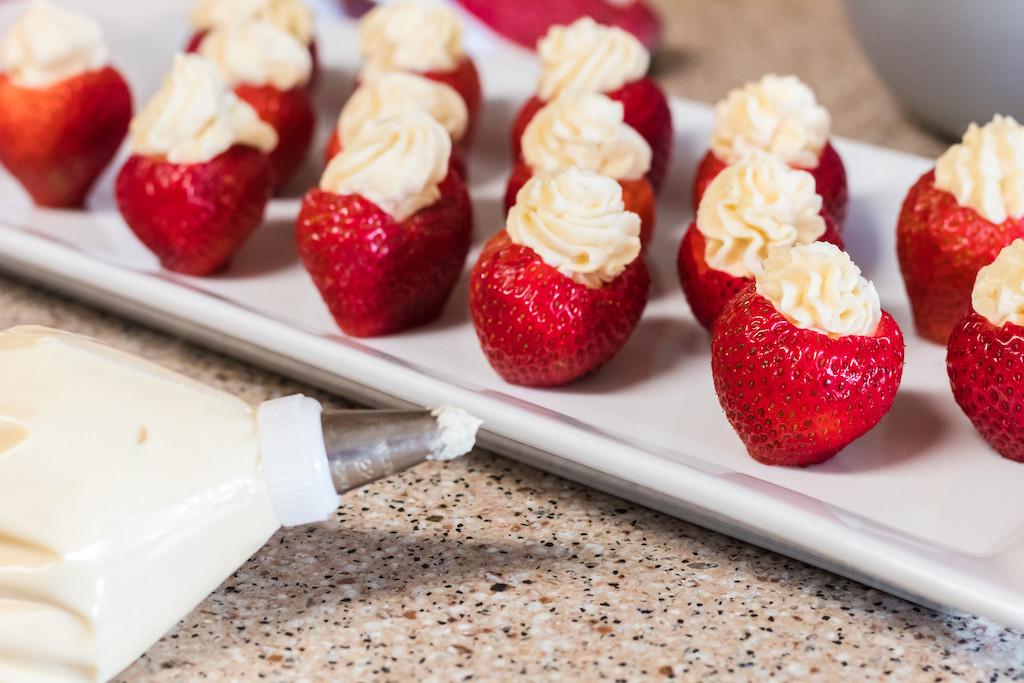 cheesecake stuffed strawberrie on tray 