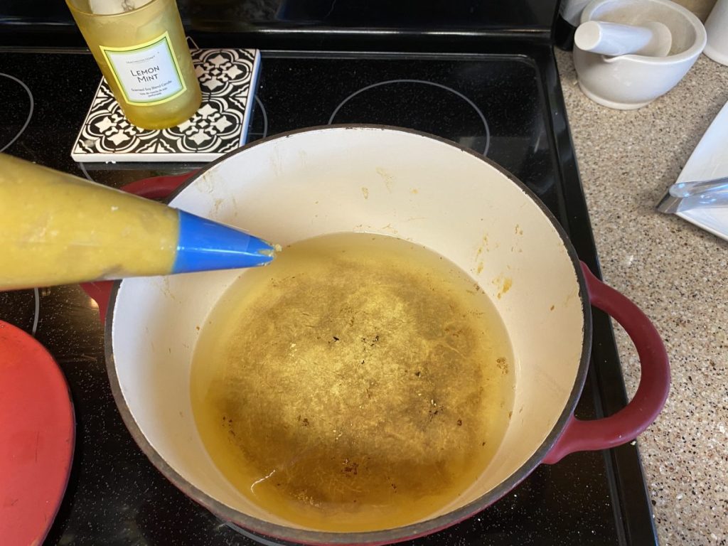 churro dough in piping bag with dutch oven 