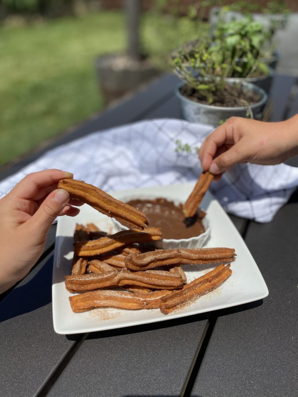 dipping churros into chocolate