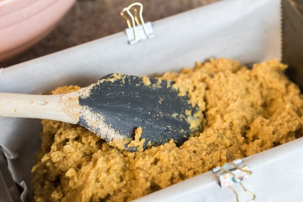 spreading bread batter in a loaf pan