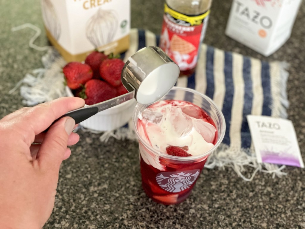 adding heaving whipping cream to a glass