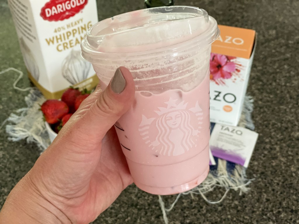 holding keto pink drink