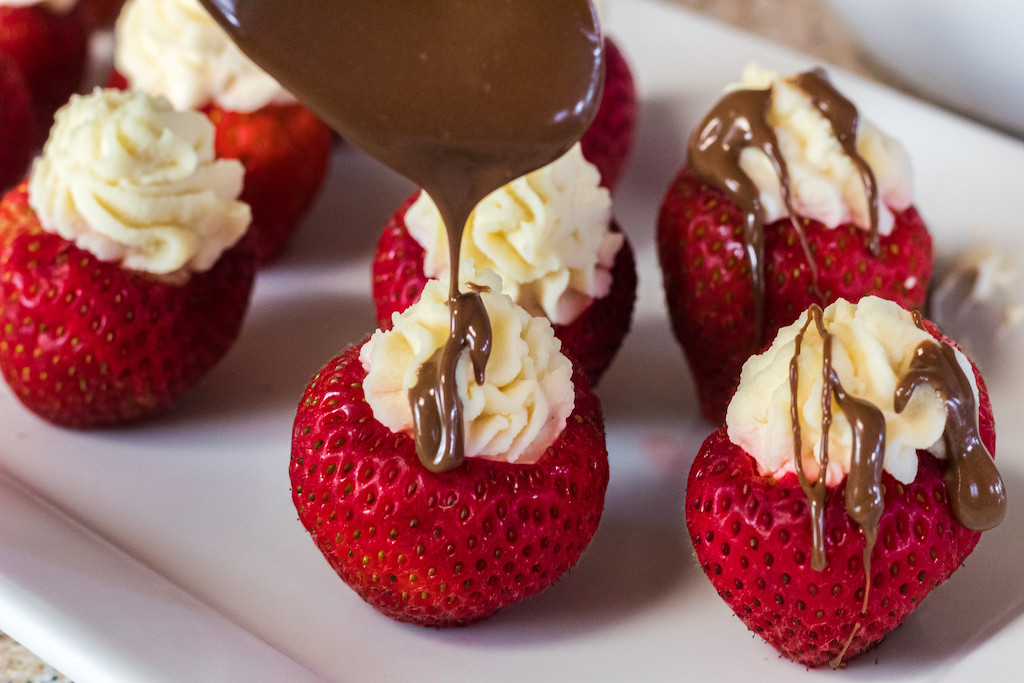 drizzling chocolate over berries 