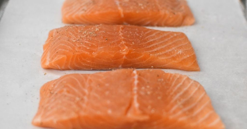 Raw salmon on a baking sheet